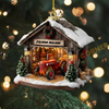 Decorative farmhouse ornament with a red tractor inside, surrounded by Christmas lights.