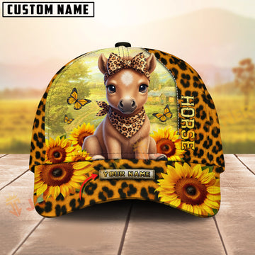 Cap with horse design, sunflowers, and leopard print on a wooden surface with a blurred natural background.