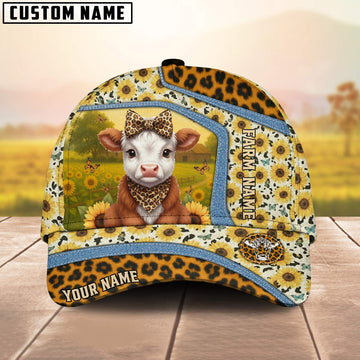 Cap with cow design and sunflower pattern on a wooden surface with blurred background