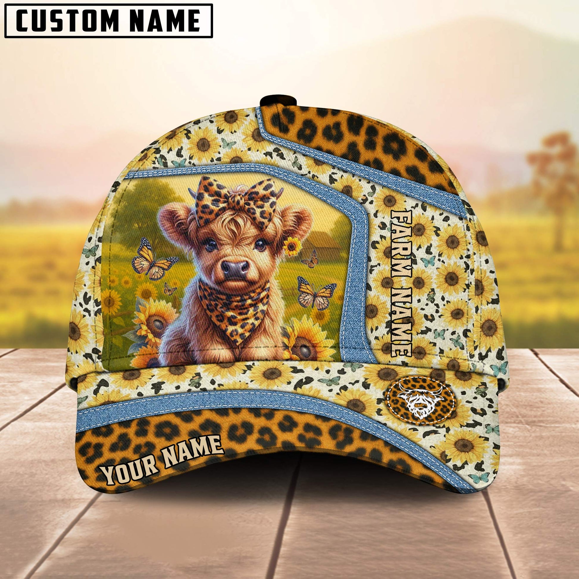 Cap with a design of a baby lion, sunflowers, and butterflies on a wooden surface with a blurred natural background.