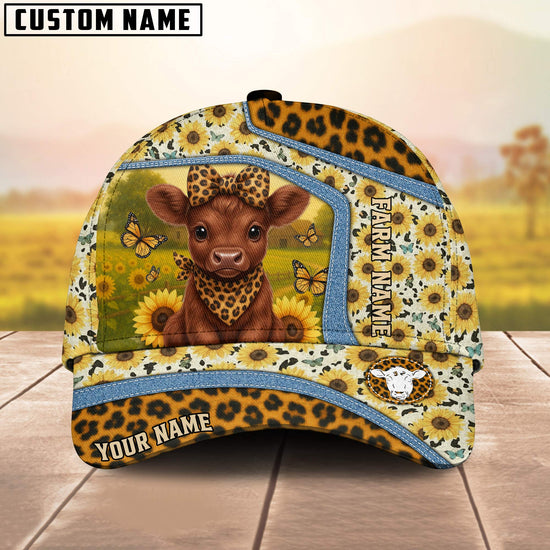 Cap with cow and sunflower design on a wooden surface with blurred background