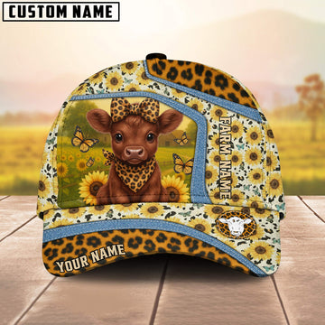 Cap with cow and sunflower design on a wooden surface with blurred background