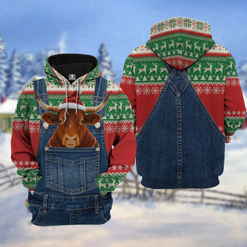 Hoodie with Christmas pattern and cow design in a pocket, set against a snowy landscape.