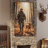 Living room with stone fireplace, plaid chairs, and a painting of a hunter and dog on the wall.